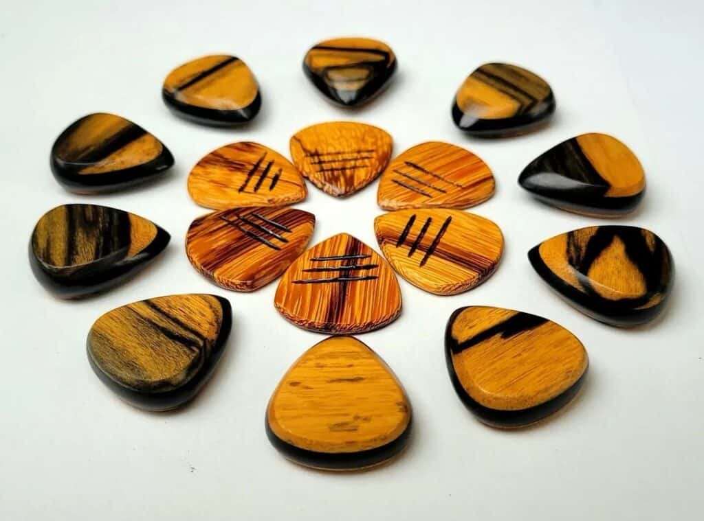 A collection of wooden guitar picks by GT Plectrums