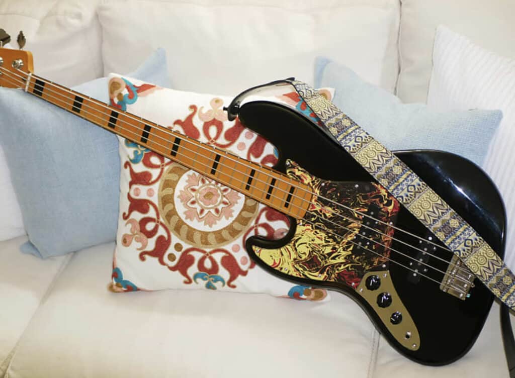 a bass guitar with a custom pickguard
