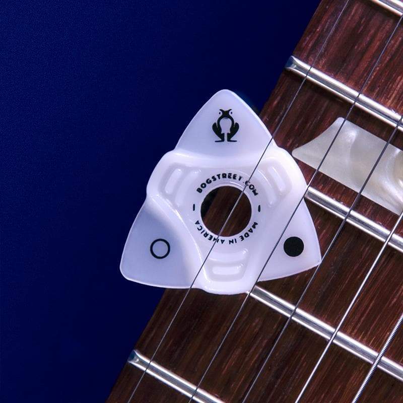 bog street's Leap ergonomic guitar pick placed on a guitar neck