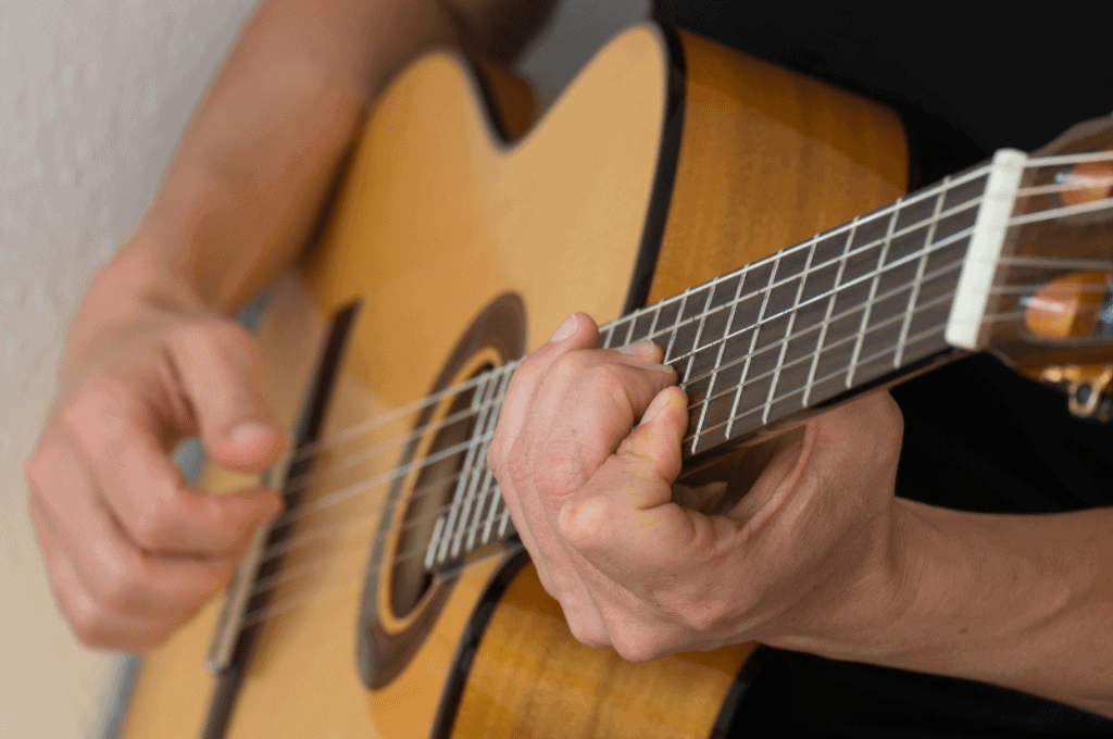 a man start playing guitar after a long break