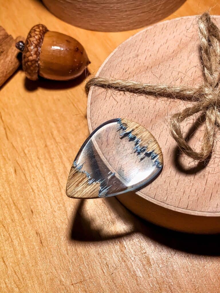 beautiful clear resin and wood guitar pick by Handsland