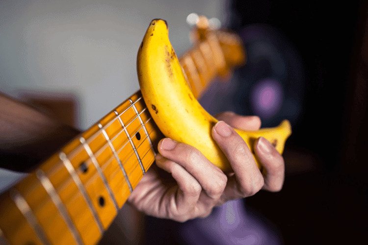 playing slide guitar with a banana