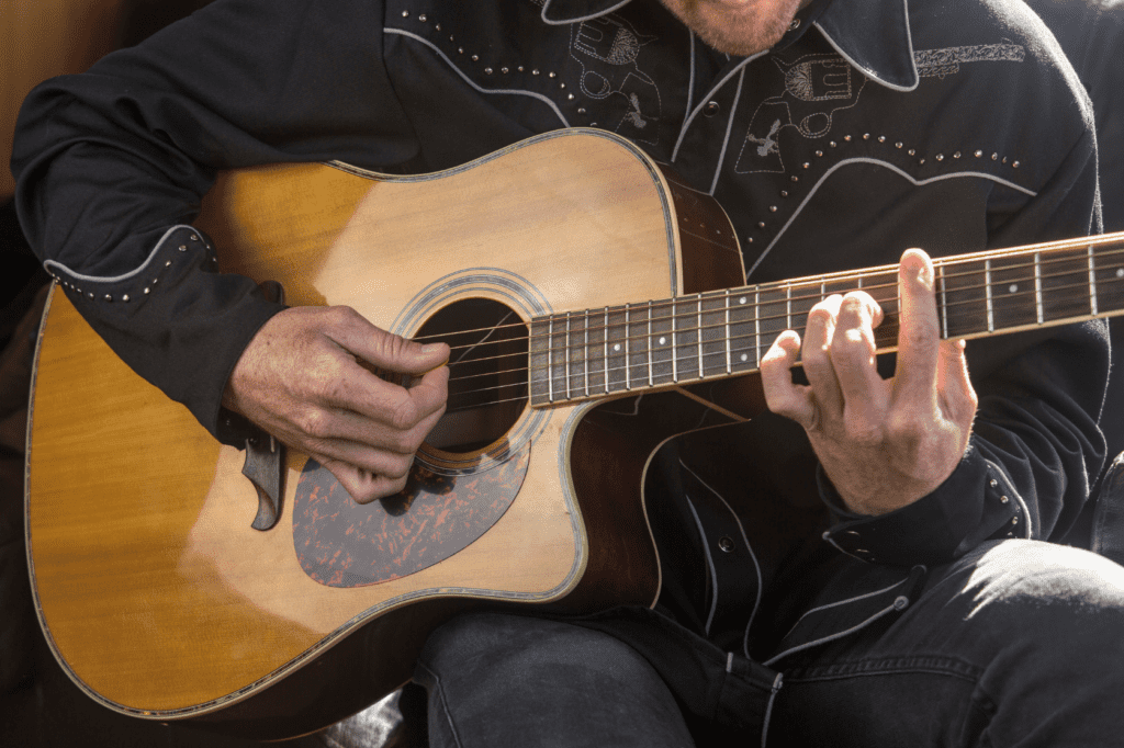 country guitar player demonstrates hybrid picking