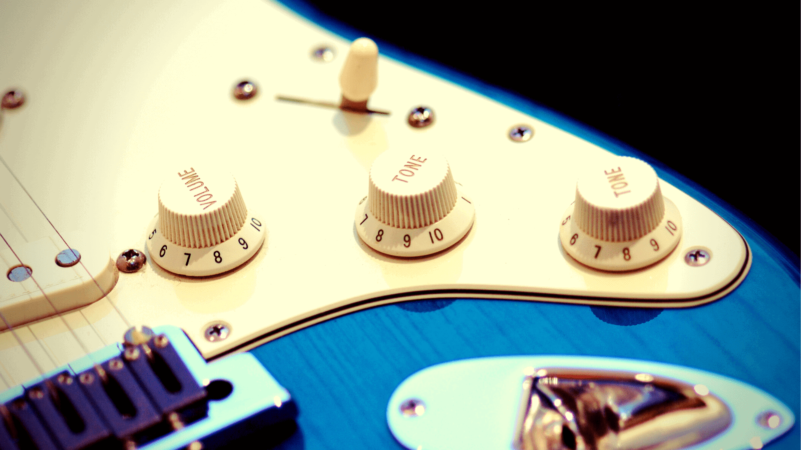 Volume and tone knobs of an electric guitar
