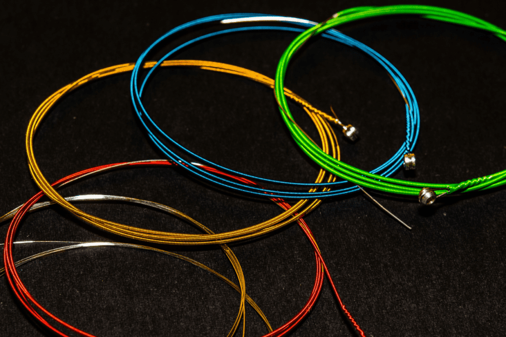 Colored guitar strings on a black background