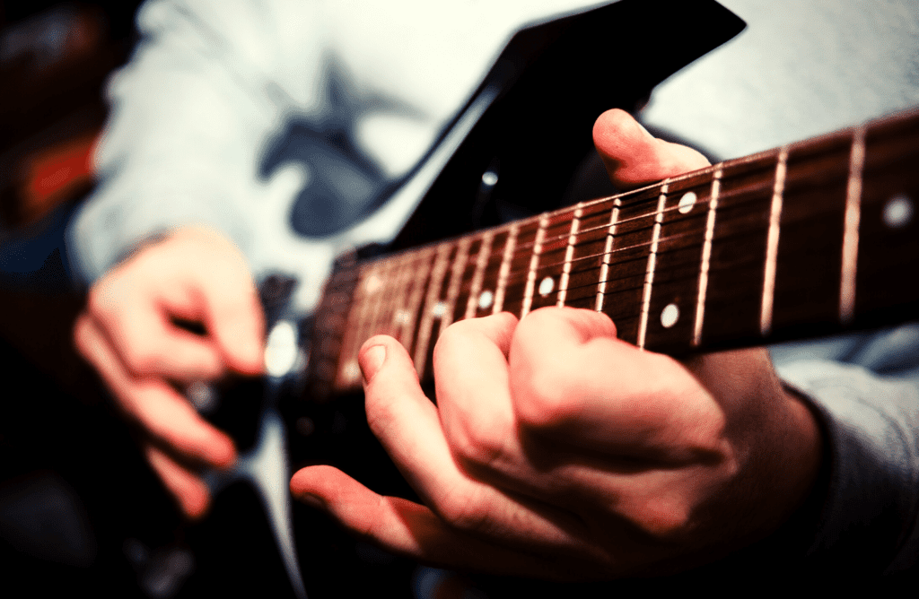 a guitar player plays a boring guitar lick, works on improving it