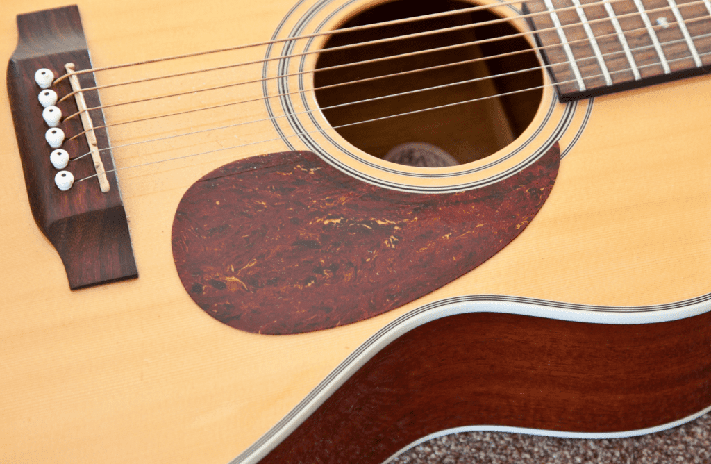 An Acoustic Guitar With A Celluloid Pickguard