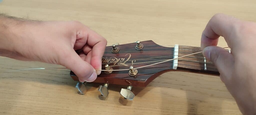 Pull back an inch and a half - giving yourself some room to tie the luthier knot