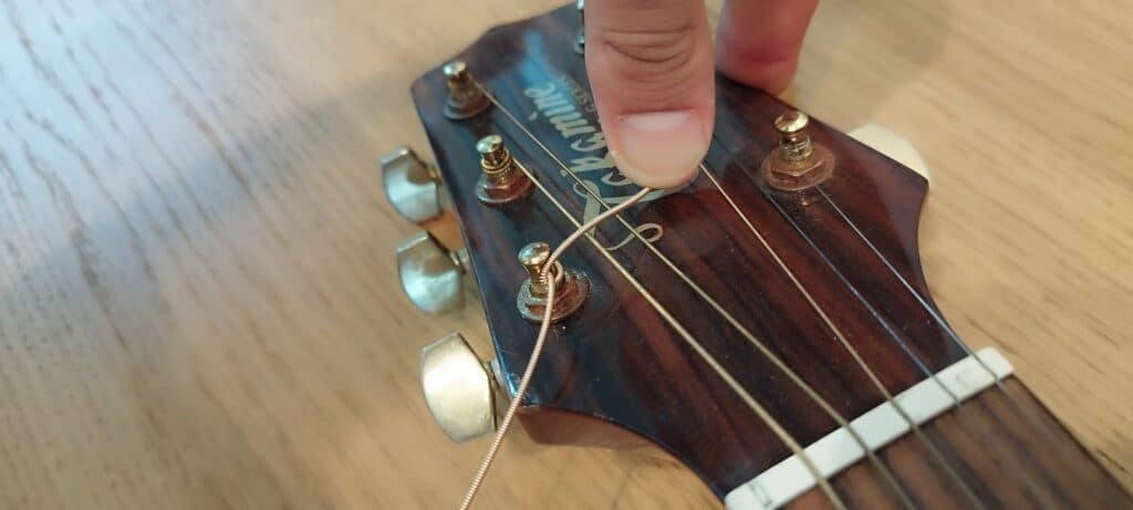 Take the excess and fold it on the rest of the string