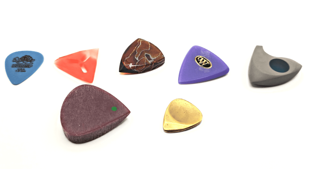 Guitar picks of different gauges and shapes
