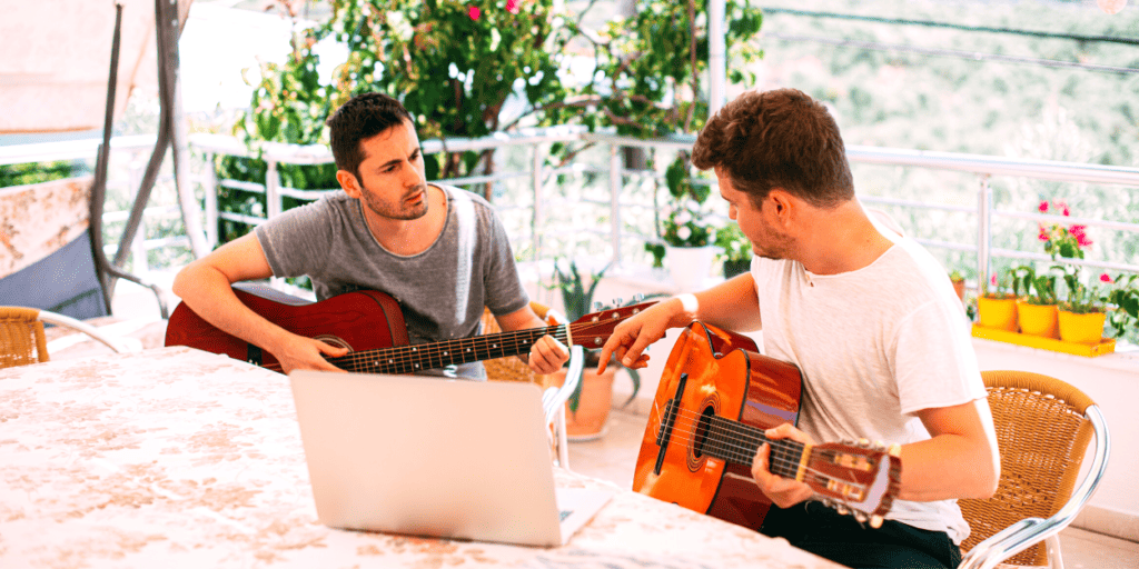 A beginner guitar player learns to play easy songs with his friend