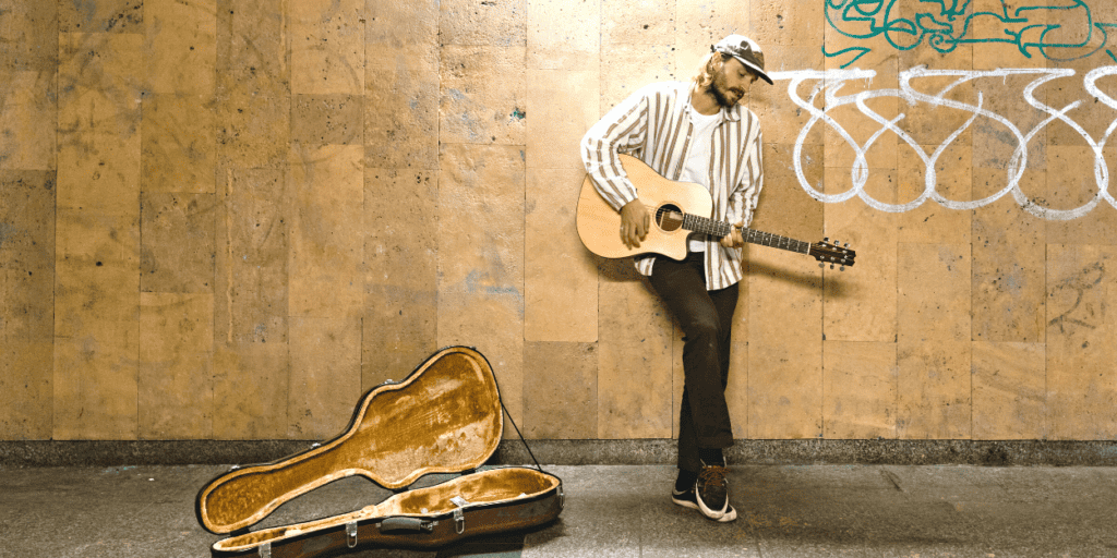 A guitar player busking in the subway