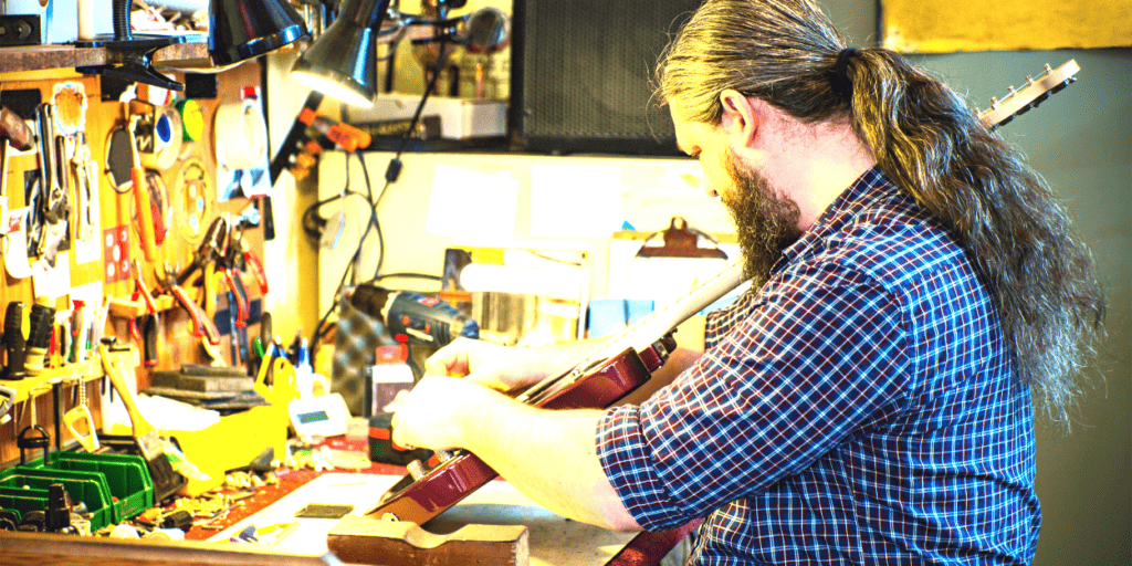 A guitar tech earns money from setting up a guitar
