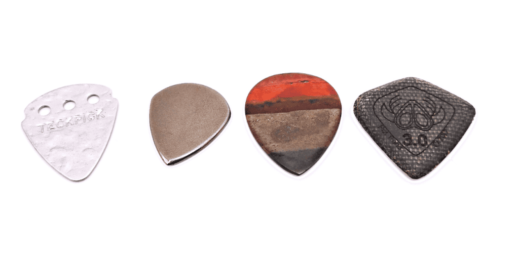 Metal Picks (TeckPick, Ohm Picks), Stone Pick (Third Stone Picks), and a chirp-less pick by SixStringers