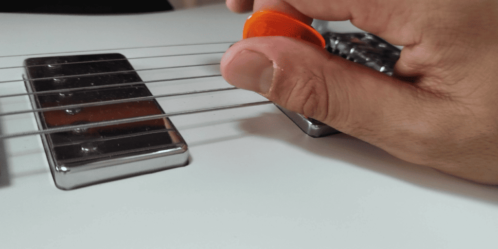 The side of the thumb lightly touches the string for a brief second. Too soft and it won't produce the squel, too hard and it will mute the note
