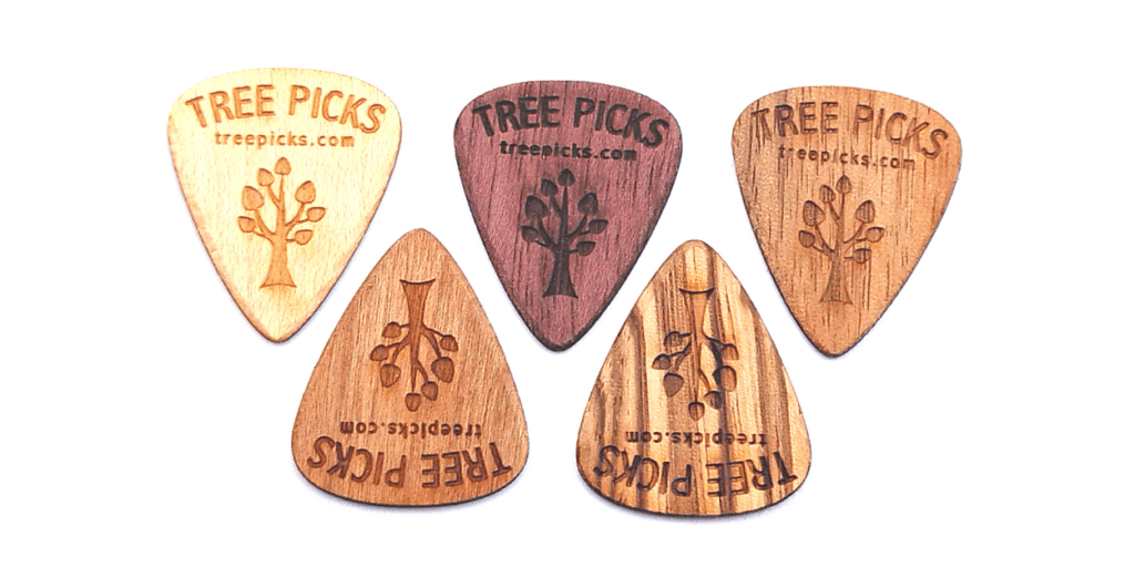 Wooden guitar picks made by Tree Picks, from left to right_ Cherry, Maple, Purpleheart, Walnut, and Zebrawood