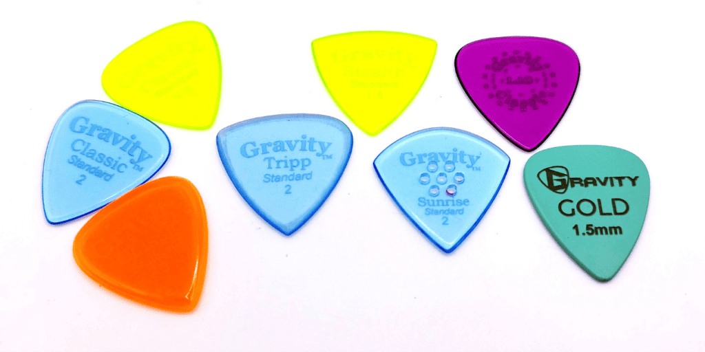 Gravity Picks (from left to right_ Classic, Tripp, Stealth, Sunrise, Thin Classic, and Colored Gold)